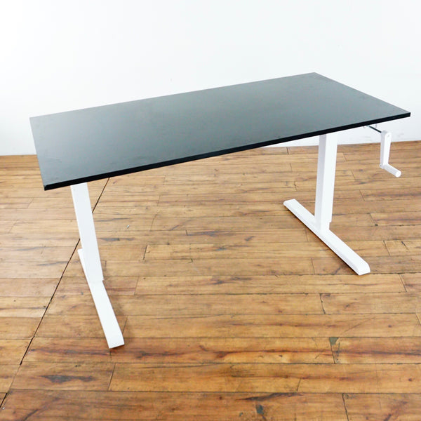 1. Manual Reperch desk with metal frame and laminate top, featuring a hand crank and maker’s stamp.