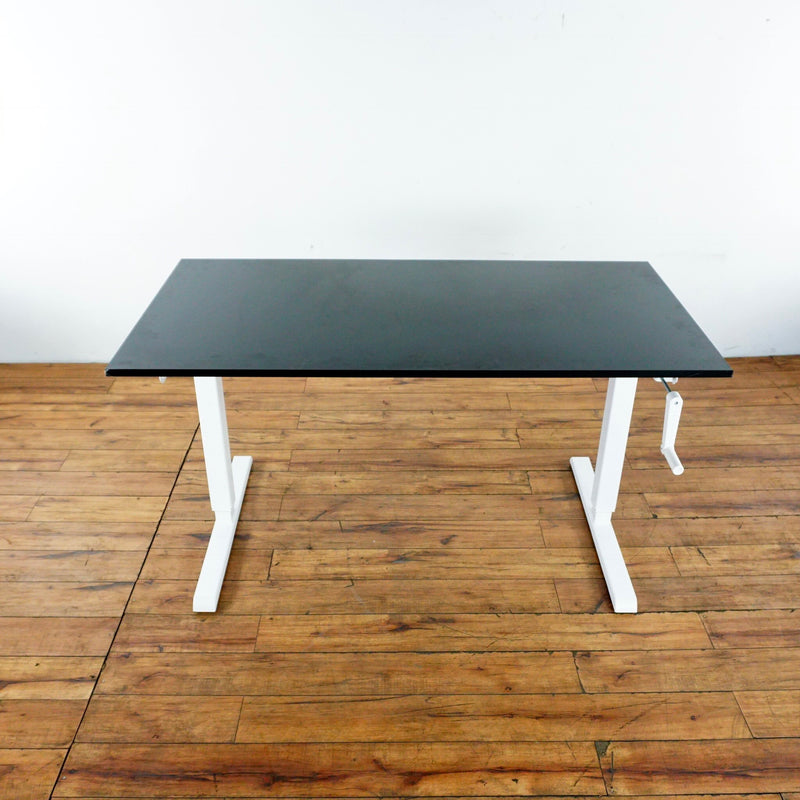 2. Sturdy metal Reperch desk with black laminate top, hand crank adjustment, and a visible maker stamp.