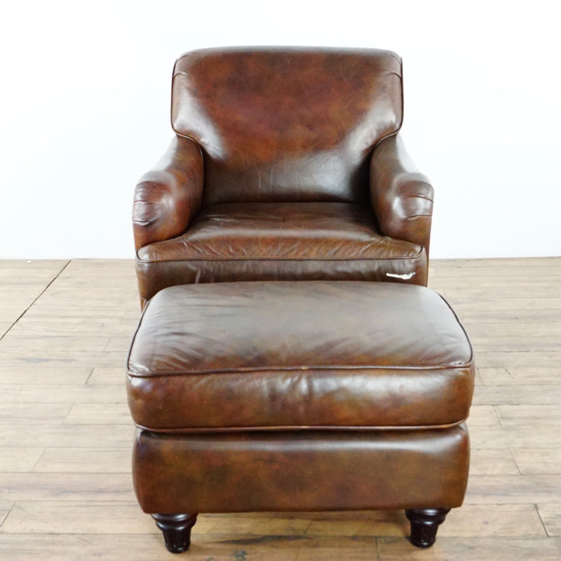 1. Brown leather Lane Furniture chair and ottoman set with paint mark on chair cushion rim, on wooden floor.