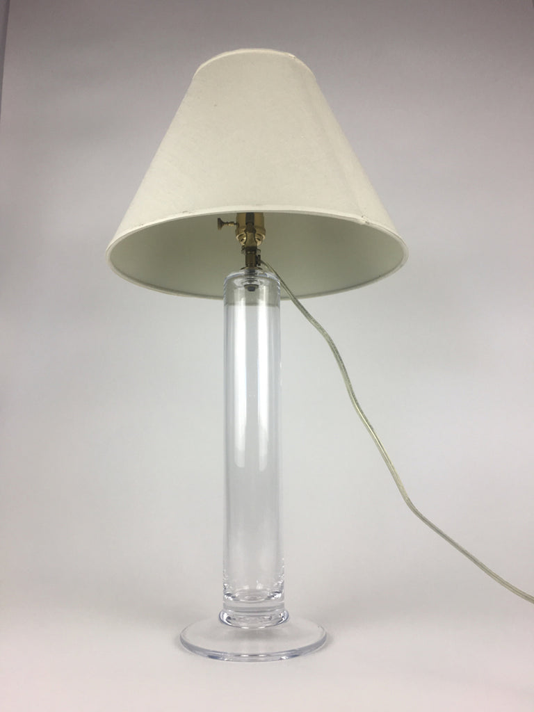 1. Table lamp by Simon Pearce with a clear handblown glass base and linen shade, electrical cord visible.
