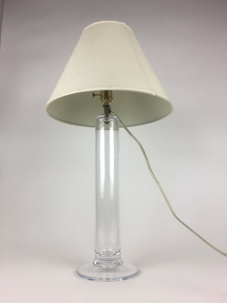 1. Table lamp by Simon Pearce with a clear handblown glass base and linen shade, electrical cord visible.