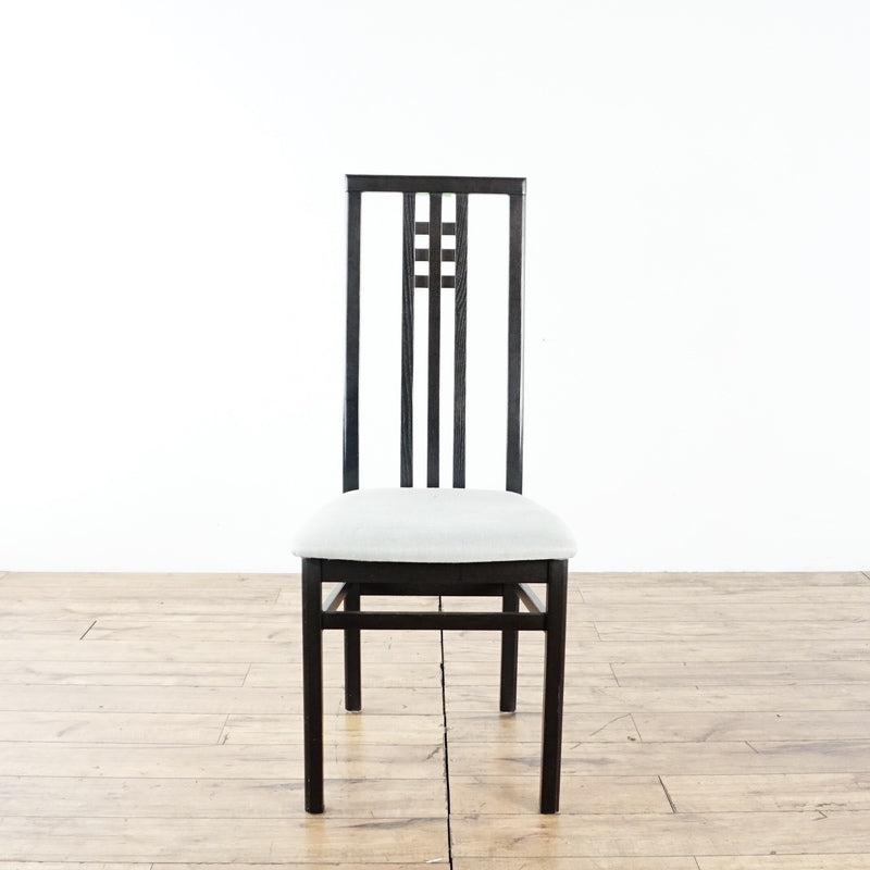 2. Single IMS dining chair made in Italy, featuring a tall black frame and fresh light upholstery, on wooden floor.