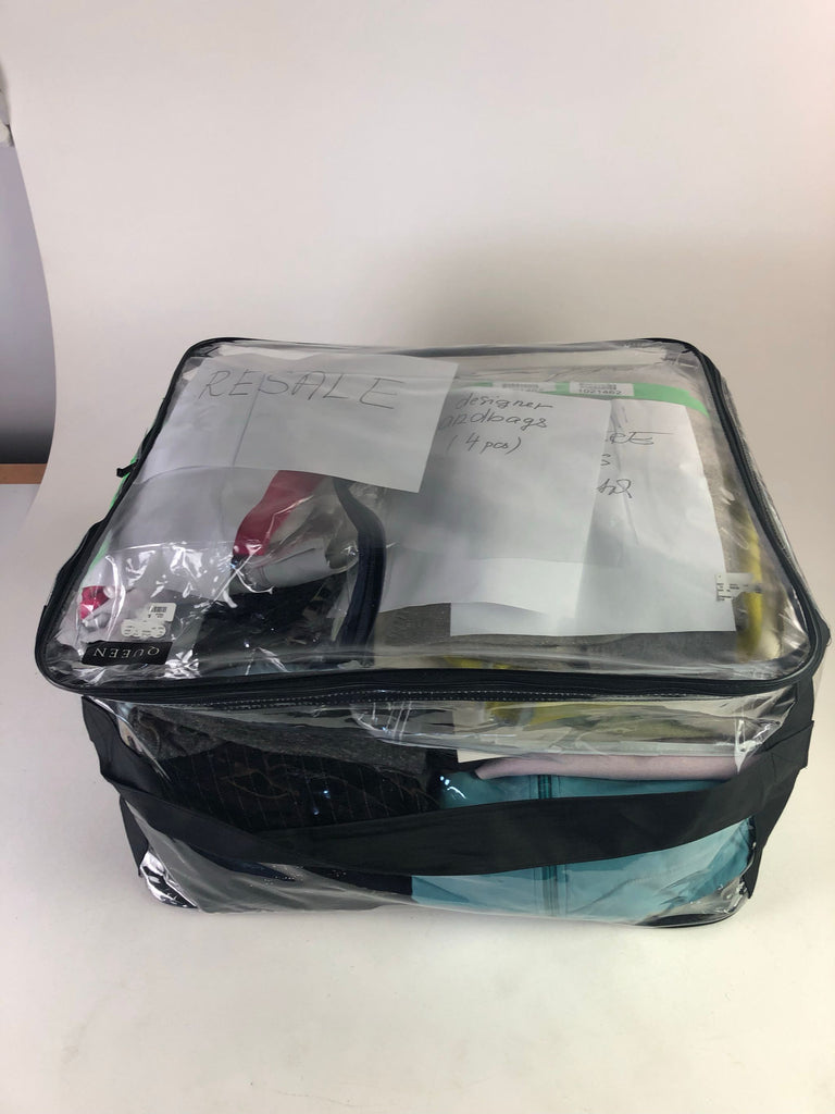 2. Large clear Reperch bag for women, packed with assorted clothes and papers marked "RESALE" and inventory notes.