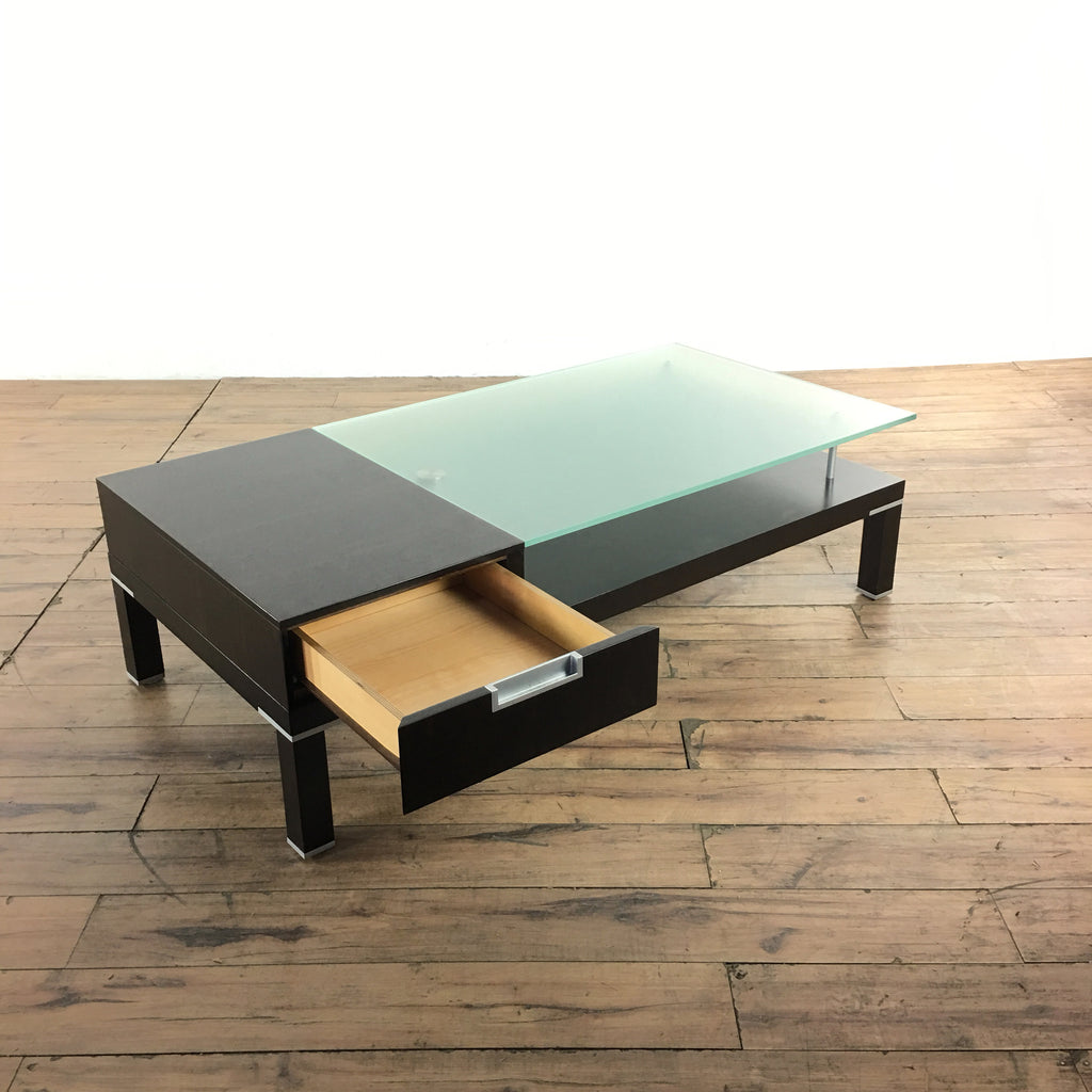 2. Reperch coffee table showing open drawer, featuring opaque glass, two drawers, and chrome fittings.
