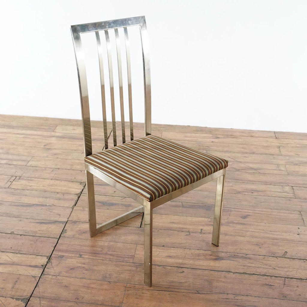 3. Angled view of Crate & Barrel dining chair featuring a chrome frame and striped upholstered seat.