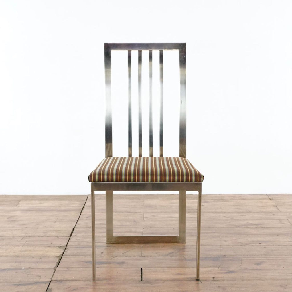 2. Single chrome-framed dining chair with striped cushioned seat, part of Crate & Barrel dining set.