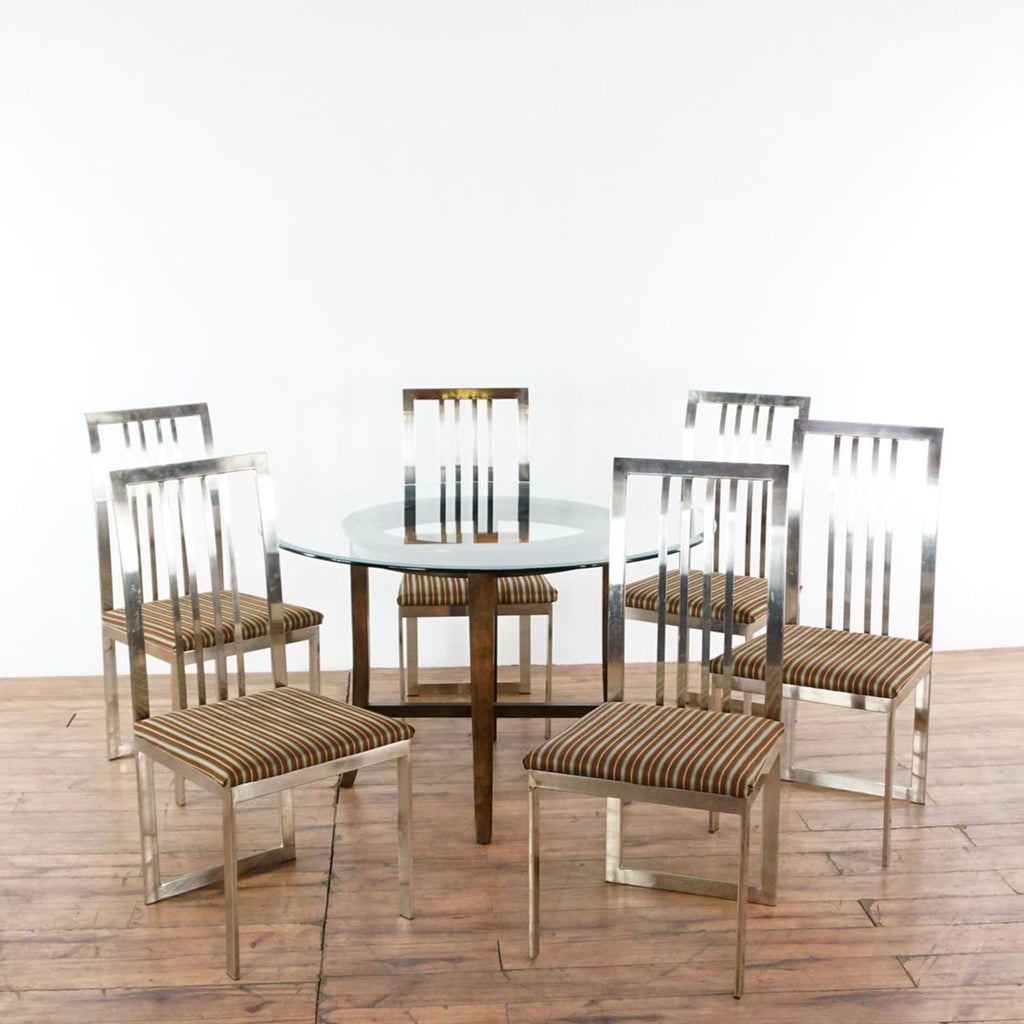 1. Crate & Barrel dining set with round glass top table, wooden base, and six chrome-framed striped chairs.