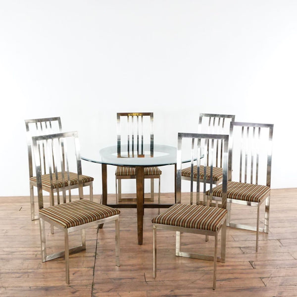 1. Crate & Barrel dining set with round glass top table, wooden base, and six chrome-framed striped chairs.