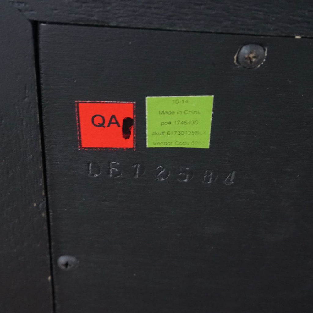 2. Close-up of the quality assurance and manufacturing labels on the back of the Restoration Hardware pine table.