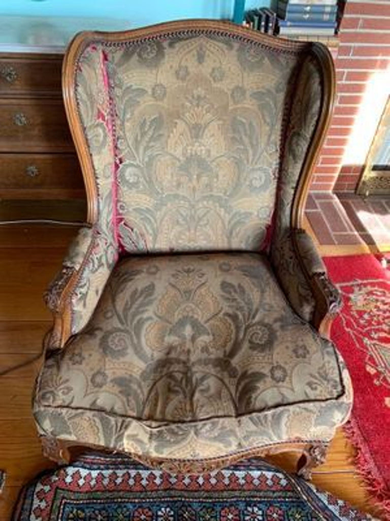 1. Ornate Reperch wingback chair with patterned upholstery and carved wood, showing wear on arms and cushion.  