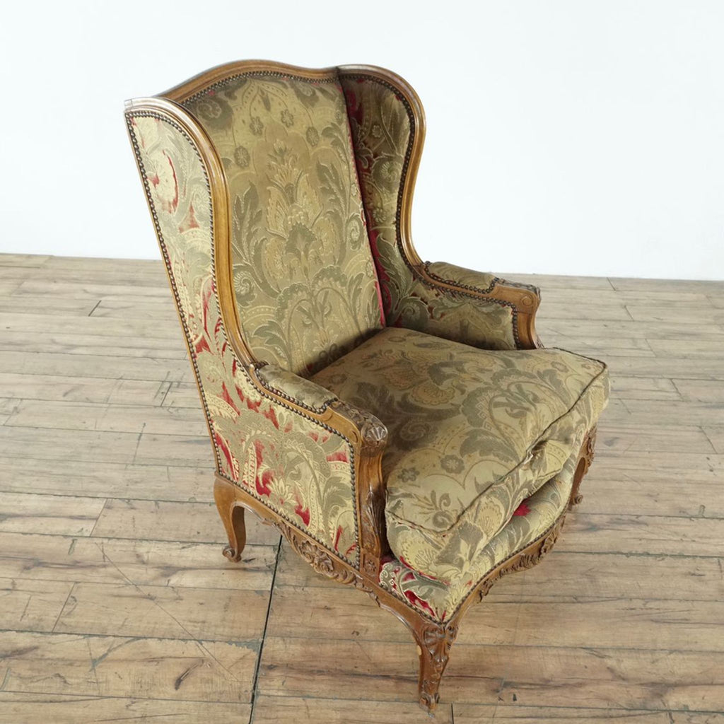 3. Vintage Reperch chair in gold and red damask fabric, ornate wood details, and a plush, slightly worn cushion.