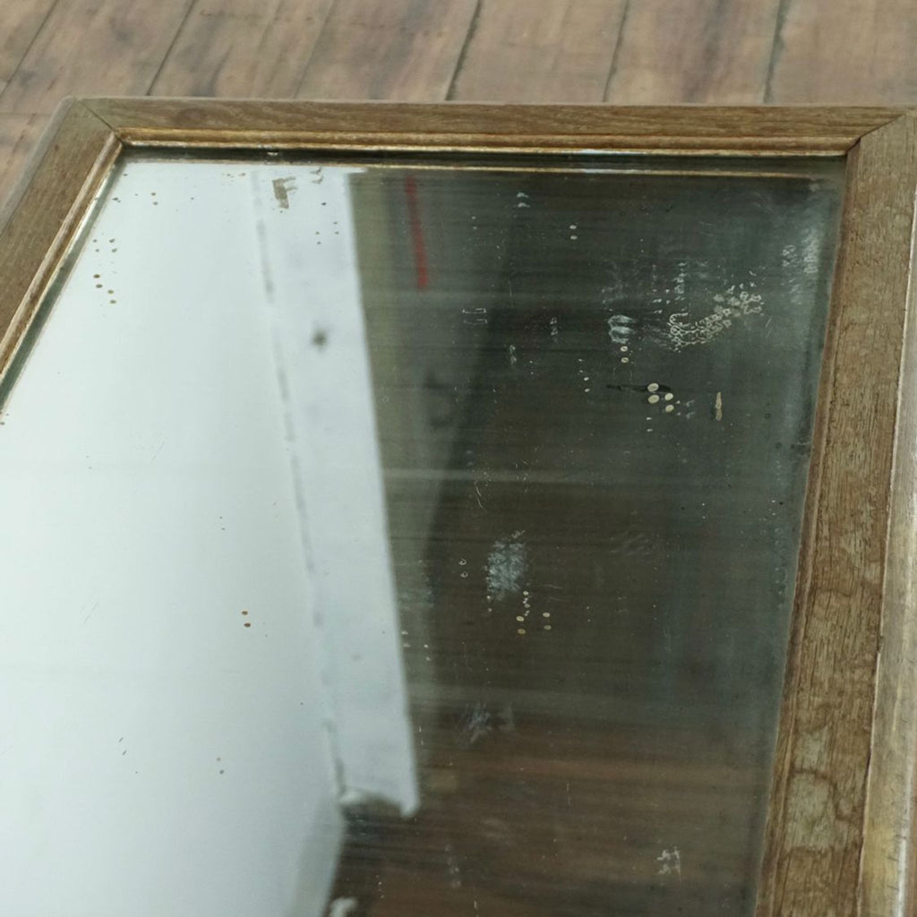 2. Close-up of the coffee table’s glass mirror top, showing its detailed frame and subtle vintage patina.
