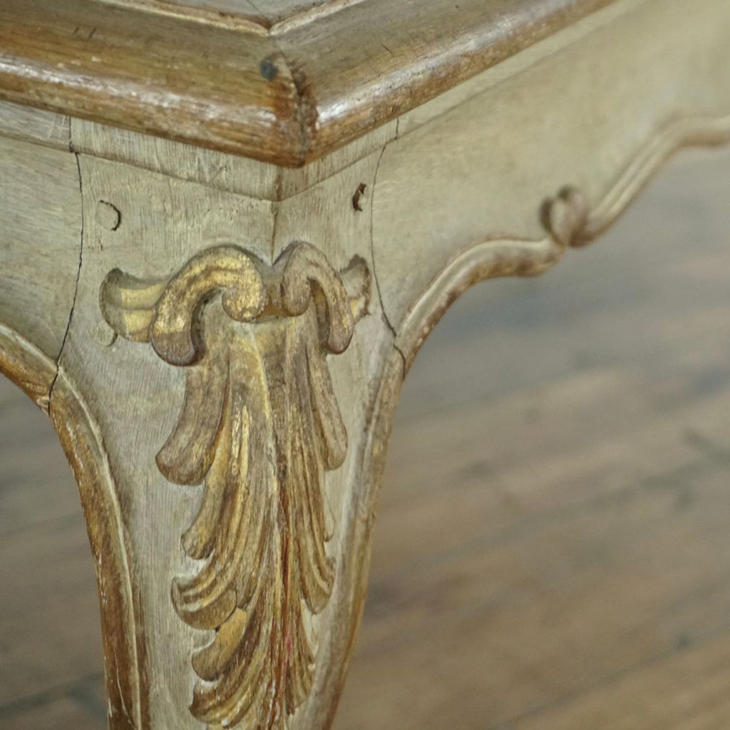 3. Detailed view of the table’s carved cabriole leg and apron, highlighting bleached gilded woodwork in Louis XV style.