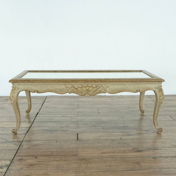 1. Rectangular French Louis XV style coffee table by Reperch, with gilded carved wood and a mirrored glass top.