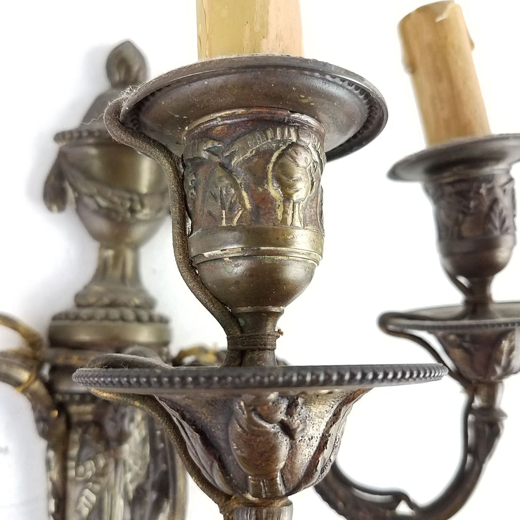 Detailed view of gilt bronze Reperch sconce showing intricate carvings and patina on the candle holder.