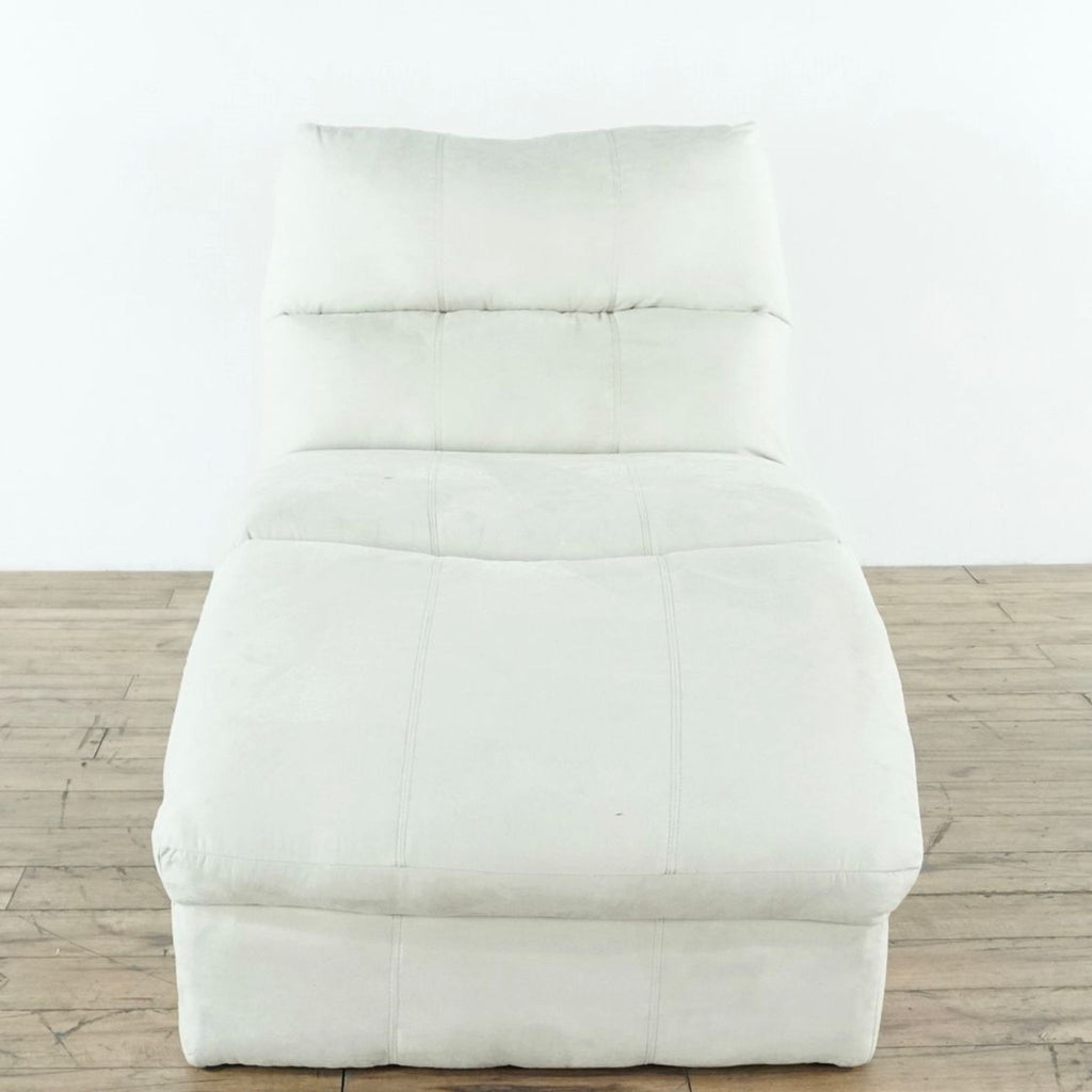 1. Front view of an unused Ashley Furniture chaise lounge sofa with cream upholstery on a wooden floor.