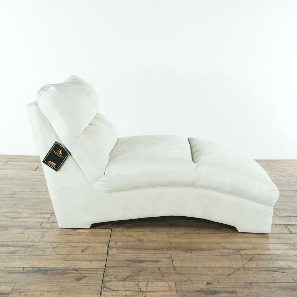 3. Side profile of an unused cream Ashley Furniture sofa with original label, showing plush cushions and curved design.