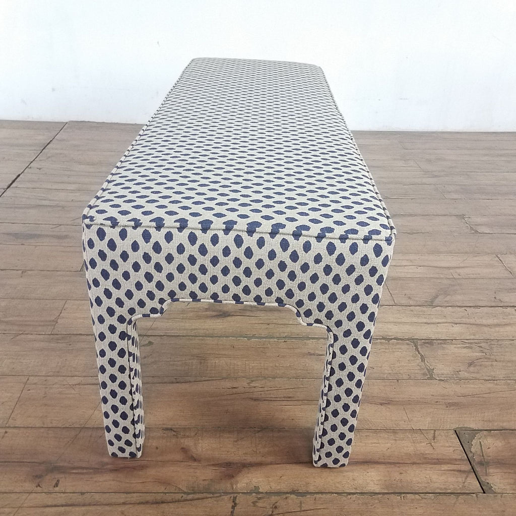 2. Close-up of Ballard Designs chair leg shows Moroccan arch detail with blue and white spotted upholstery.