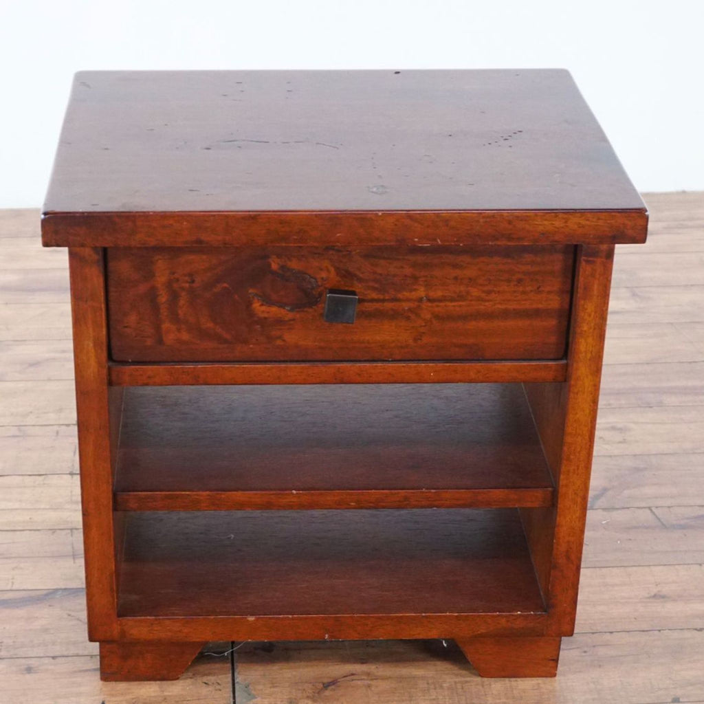 3. Top view of a Reperch end table highlighting its flat surface, single drawer, and two-tiered shelves below.