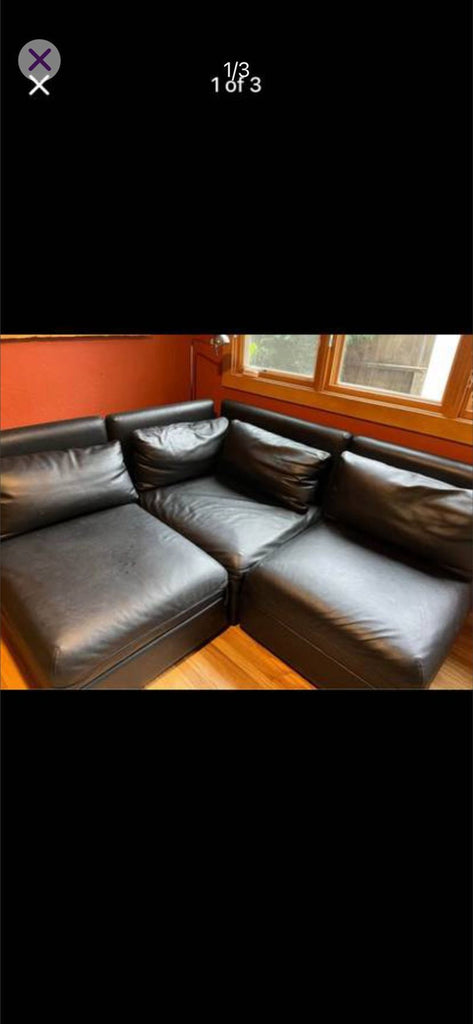 Sectional sofa set in black faux leather, featuring modular pieces, pull-out bed, and storage ottoman.