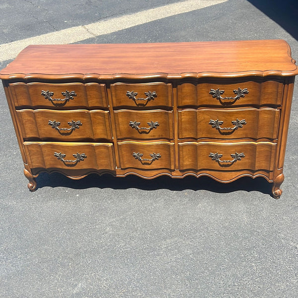 a wooden cabinet with a wooden head board 