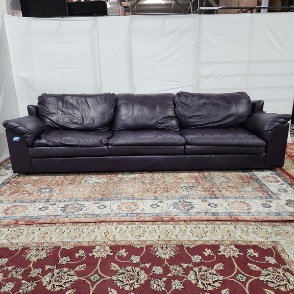 a leather sofa in a room with a white wall.