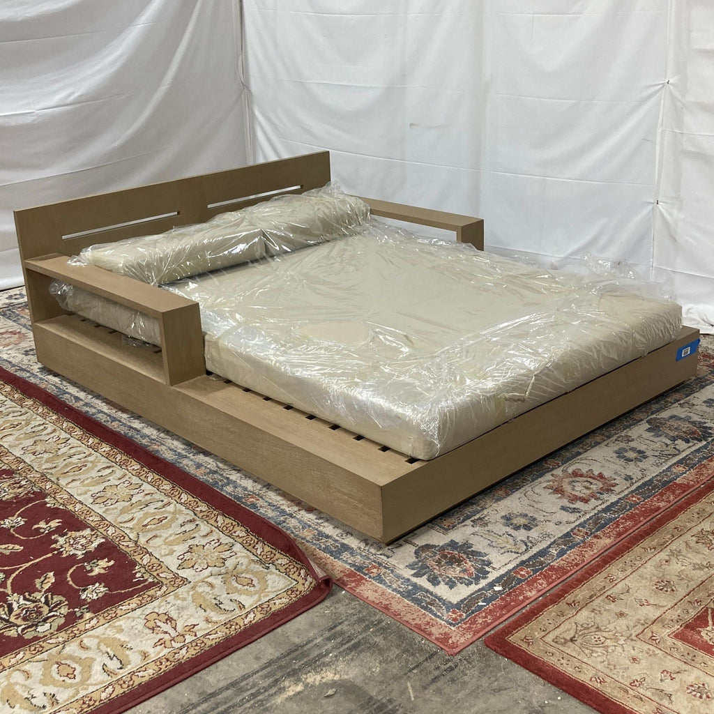 a bed frame with a wooden frame and a white sheet.