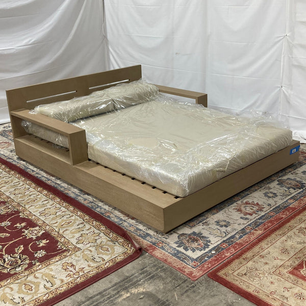 a bed frame with a wooden frame and a white sheet.