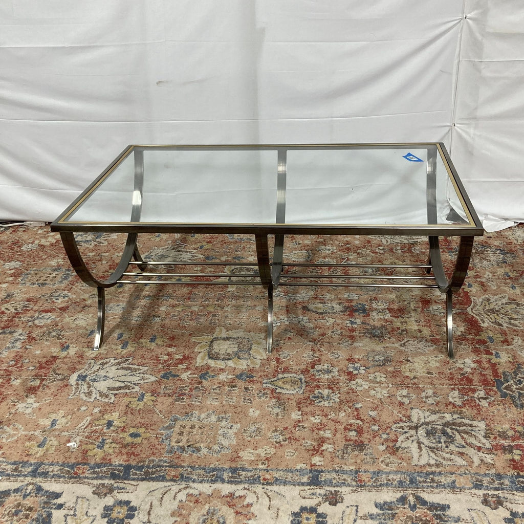 a chrome and glass coffee table with a glass top.