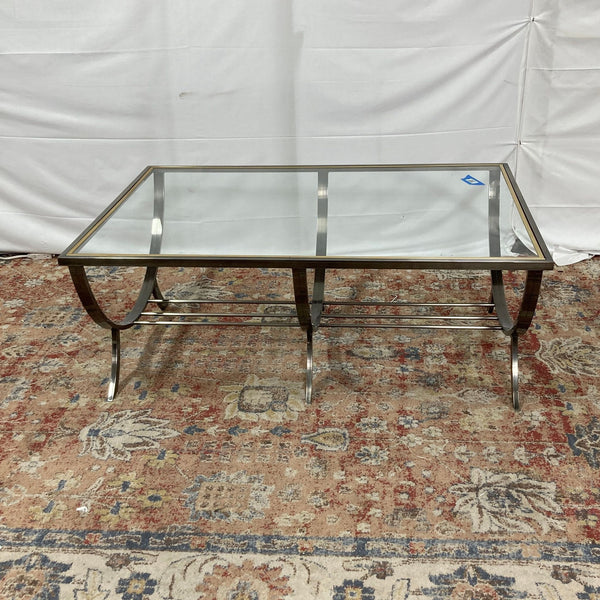 a chrome and glass coffee table with a glass top.