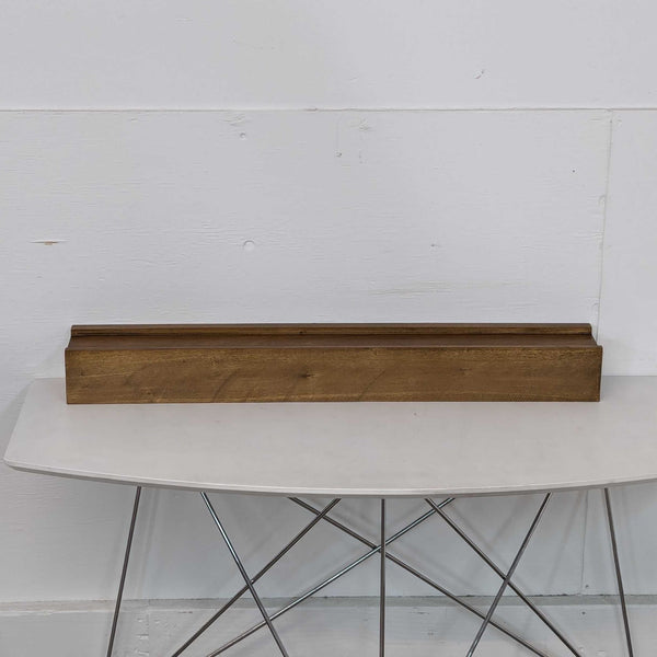 a large, rectangular, wooden table with a white table top.