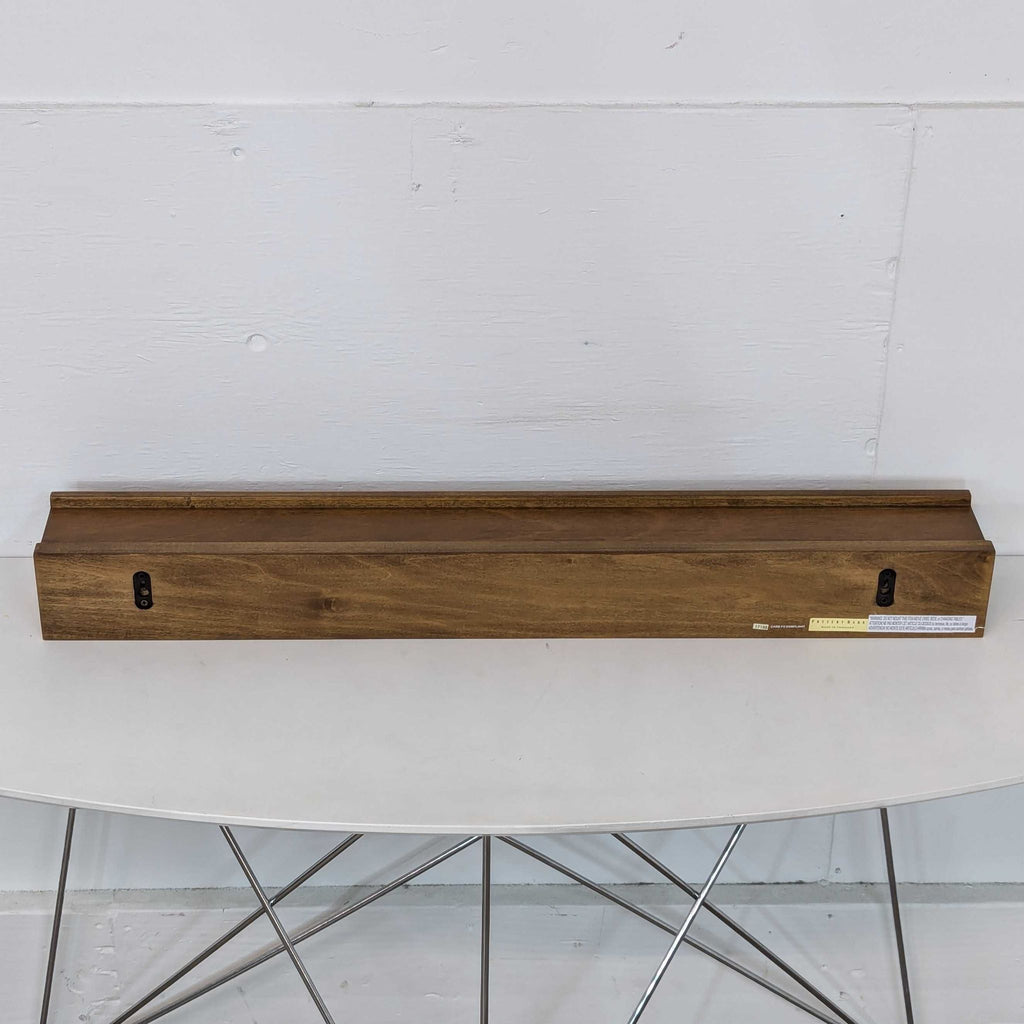 a modern walnut and brass desk top with a brass plated metal frame.