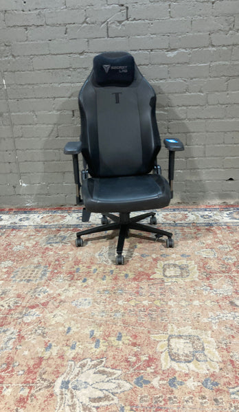 a black leather office chair with a black leather base and a black seat.