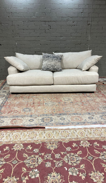 a living room with a couch, table, and rug 