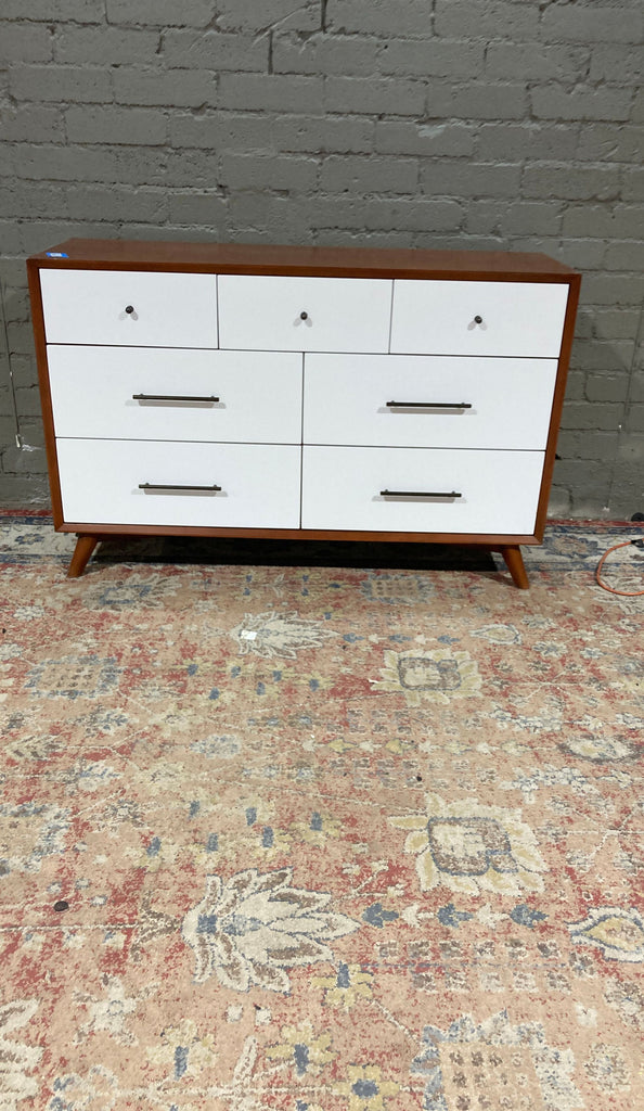 a mid century modern dresser with a white painted finish.