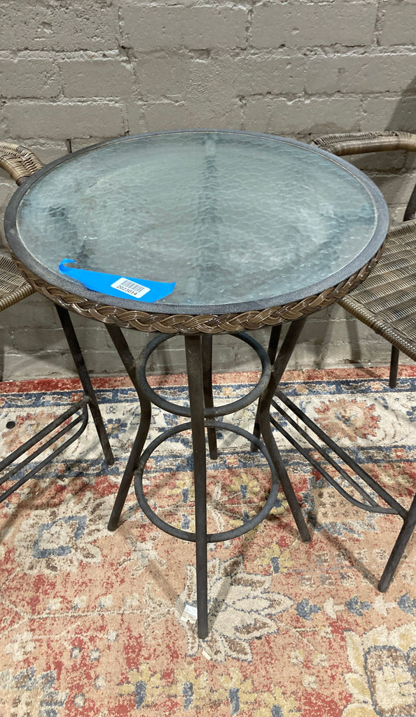 metal patio set with a round glass top and a round glass top.