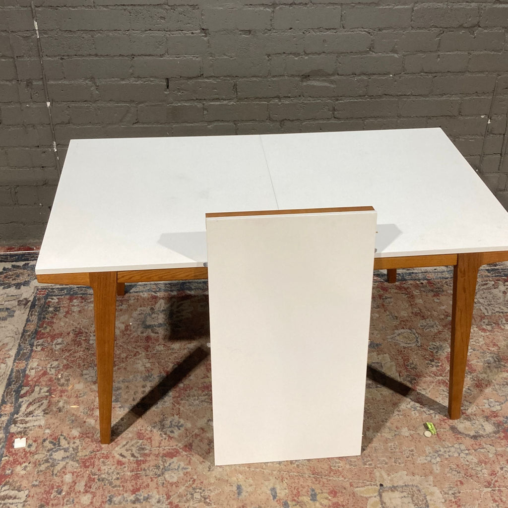 a white refrigerator sitting on top of a wooden floor 