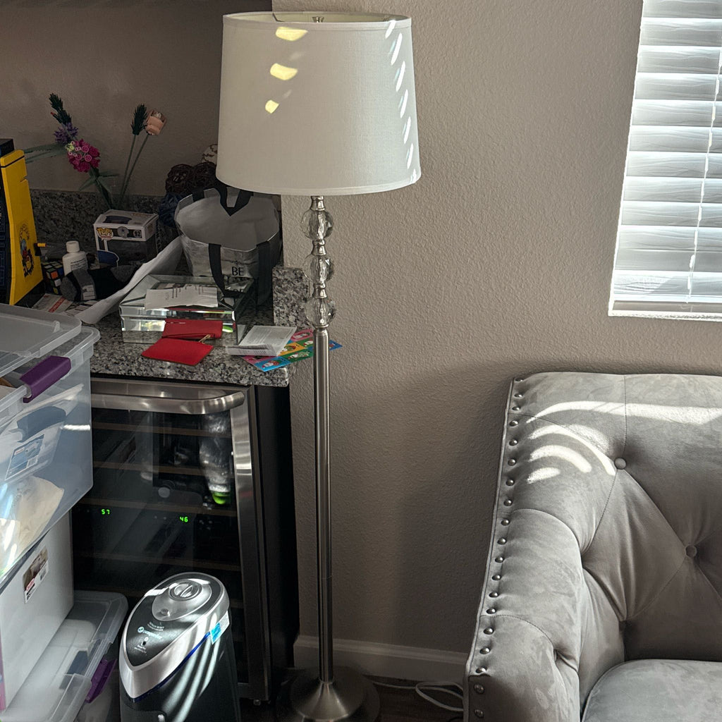 Reperch floor lamp beside a sofa in a cozy room setting.