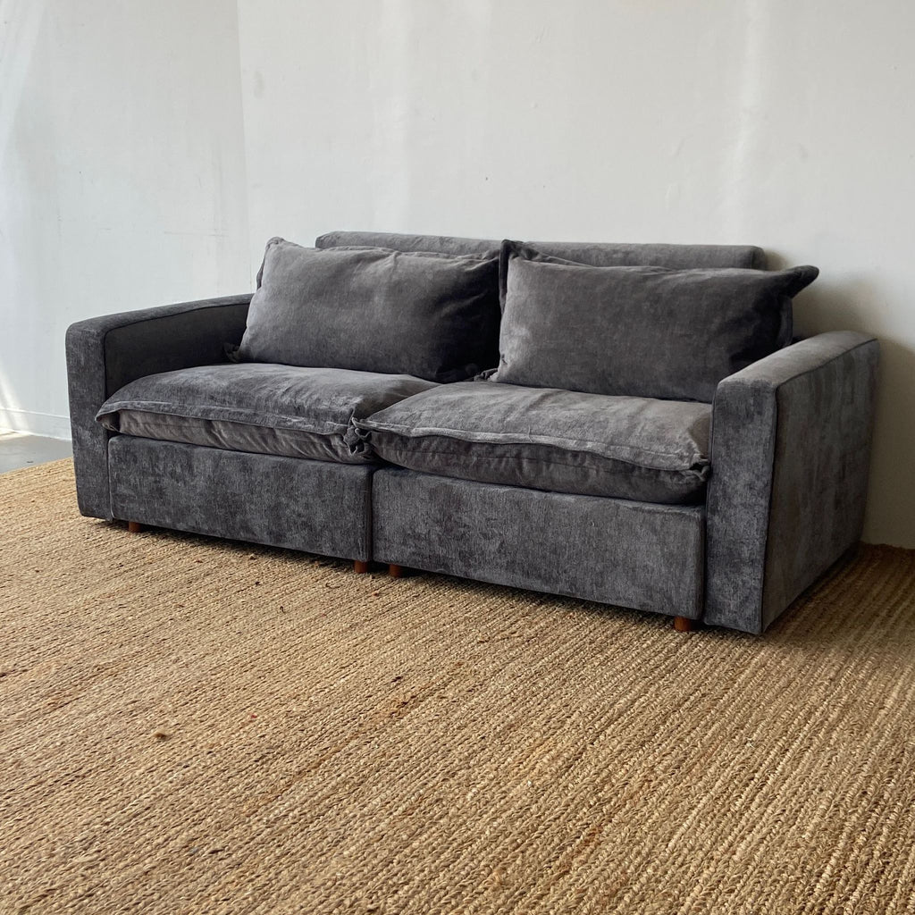 a couch with a black leather couch cushion 