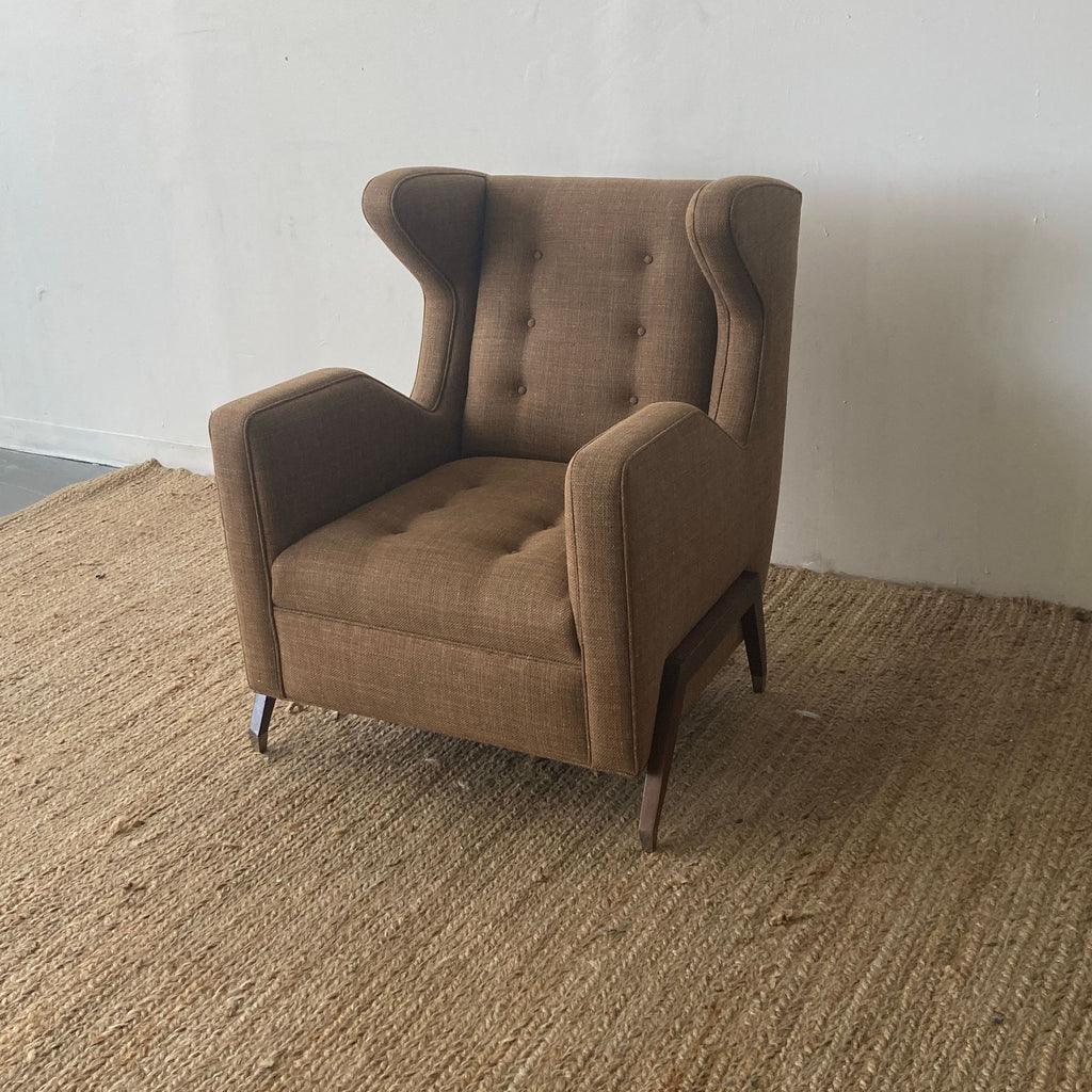 Elegant brown upholstered wingback chair with button tufting and angled wooden legs.