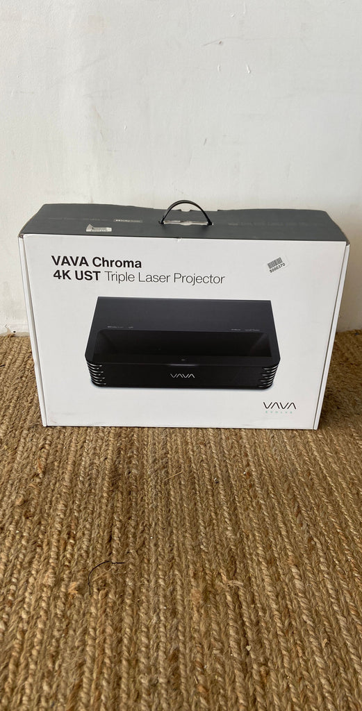 VAVA Chroma 4K UST Triple Laser Projector in box, placed on a textured surface.