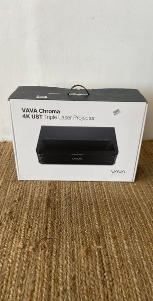 VAVA Chroma 4K UST Triple Laser Projector in box, placed on a textured surface.