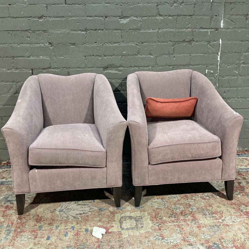 Ethan Allen armchairs in grayish pink, set against a brick wall.