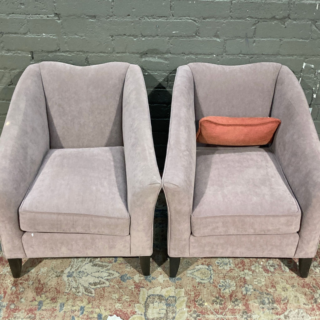 Stylish Ethan Allen chairs with dark legs and a cozy pink hue.