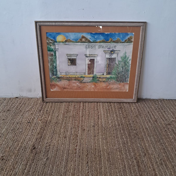 1. Framed watercolor painting of a building labeled "Casa Gonzales" with mountains and sun in the background.