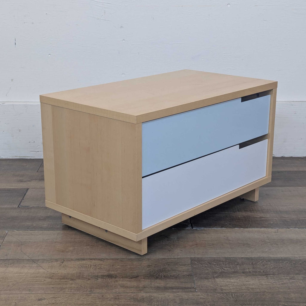 Side view of a maple chest with sleek white and ivory powder-coated steel drawer fronts.