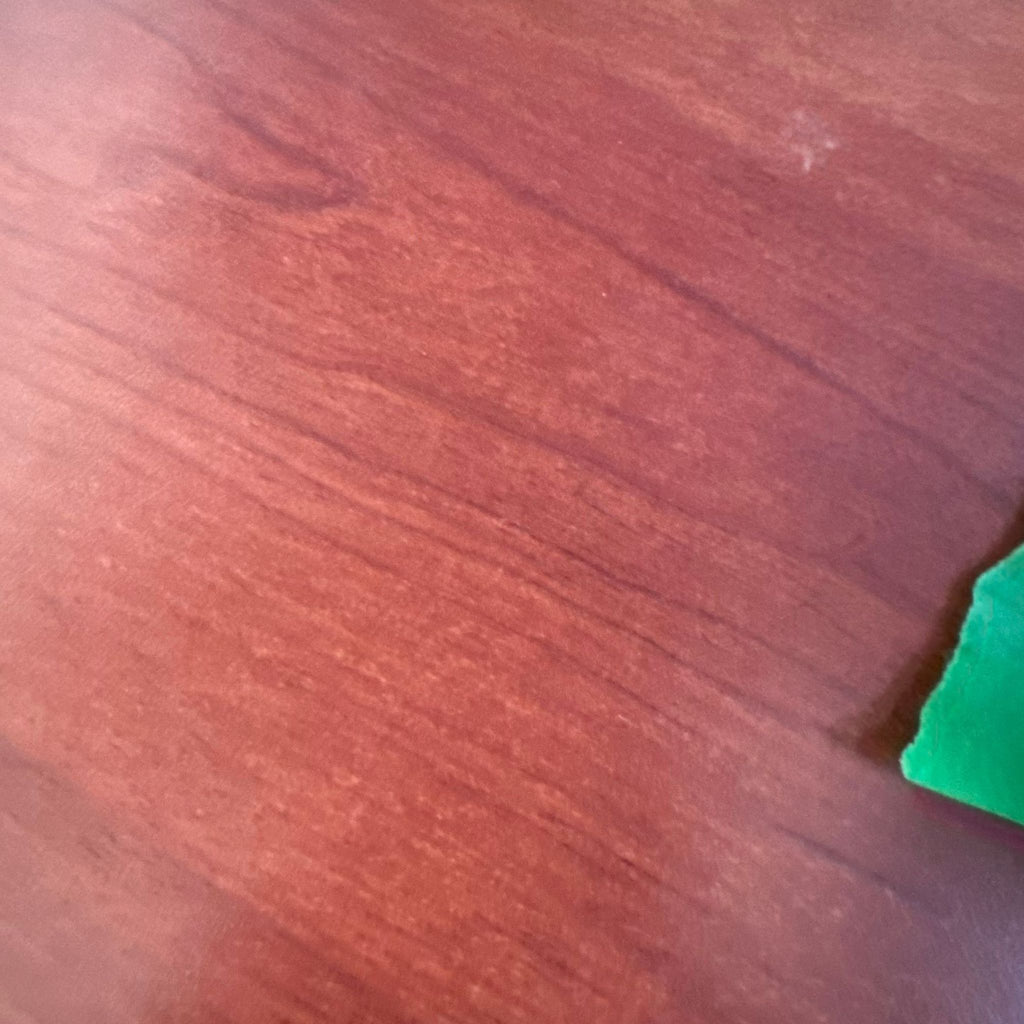 2. Close-up of reddish wood grain surface, showing natural pattern and smooth texture.