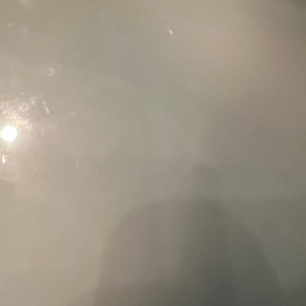 2. Close-up shot of a glossy, reflective marble surface, showing a light reflection and faint subtle patterns.