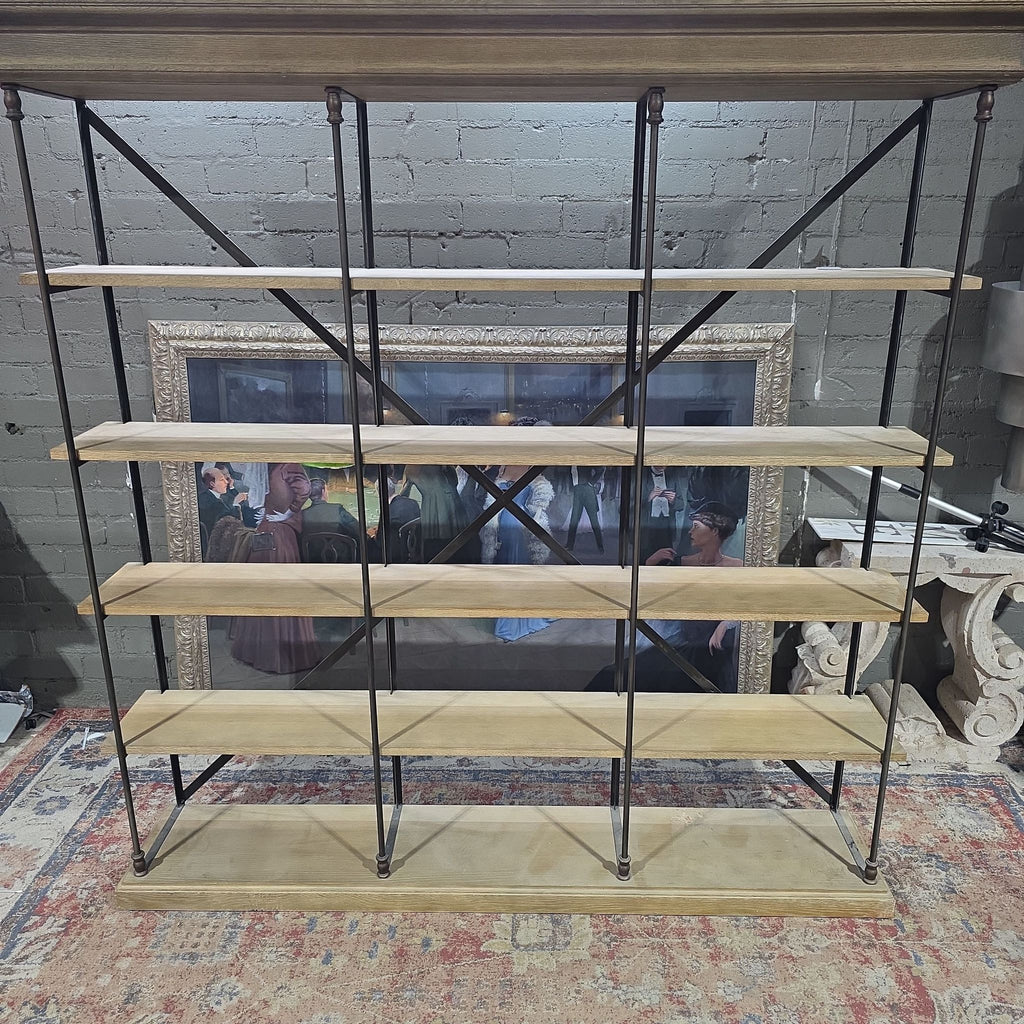 2. Large Restoration Hardware bookshelf with five wooden shelves and metal supports, pictured in a decorated indoor space.