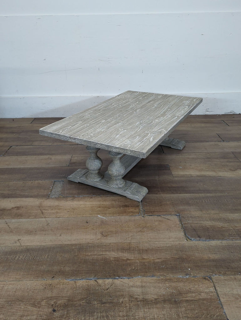 2. Reperch brand coffee table in distressed wood, displayed on a wooden floor against a white wall.